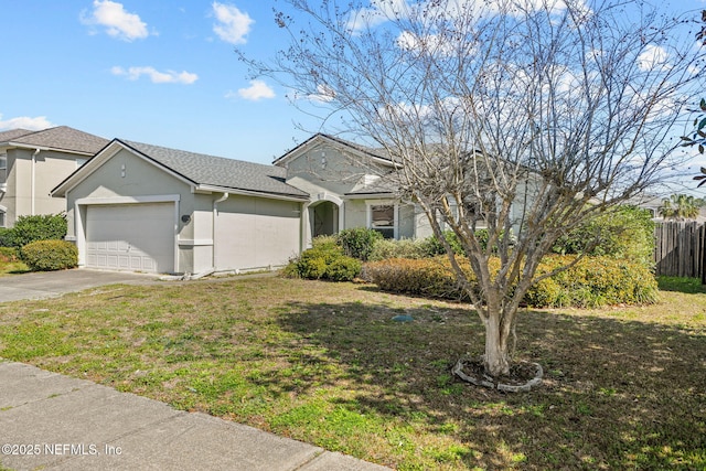 ranch-style home with stucco siding, an attached garage, a front yard, fence, and driveway