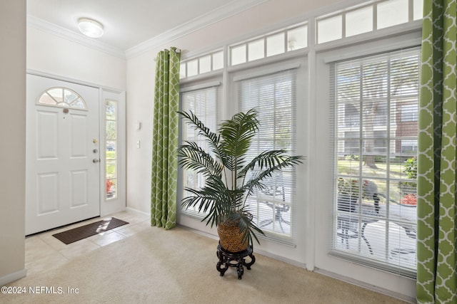 tiled entryway with carpet floors and crown molding