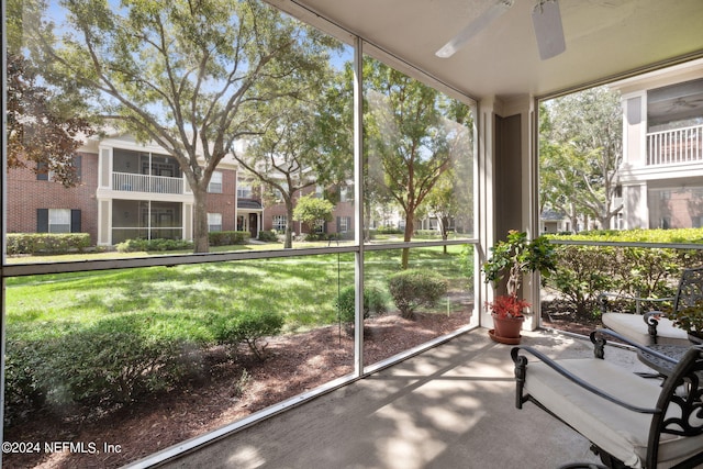 unfurnished sunroom with a ceiling fan