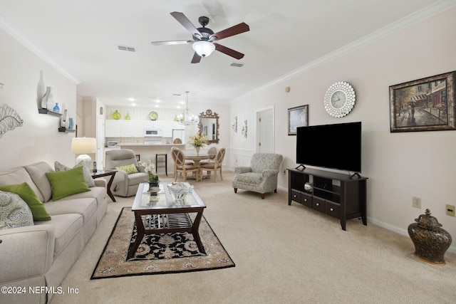 living area with ornamental molding, light carpet, visible vents, and ceiling fan with notable chandelier