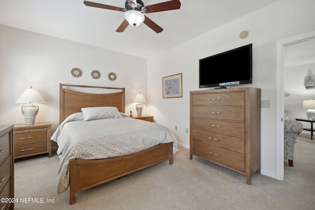 bedroom with baseboards, ceiling fan, and light colored carpet