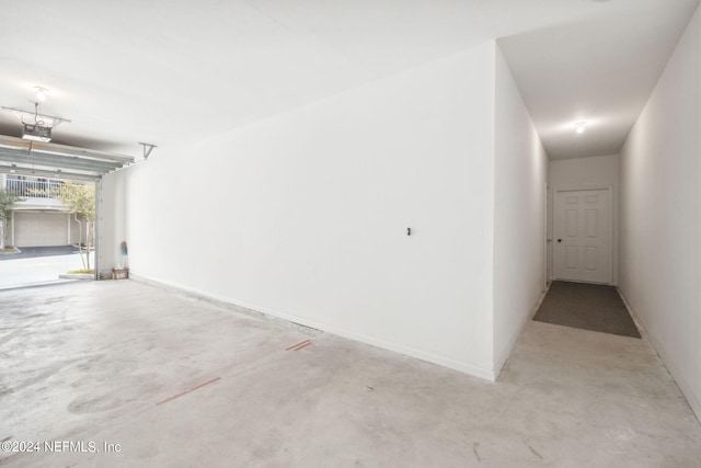 garage with baseboards and a garage door opener