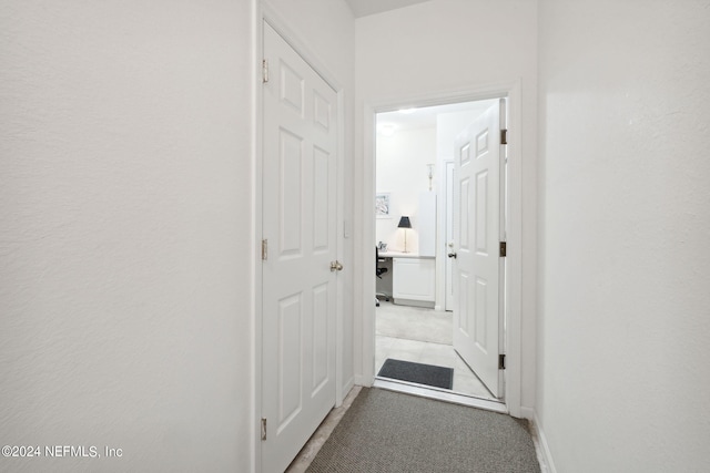 hallway featuring baseboards