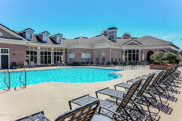 community pool with a patio area