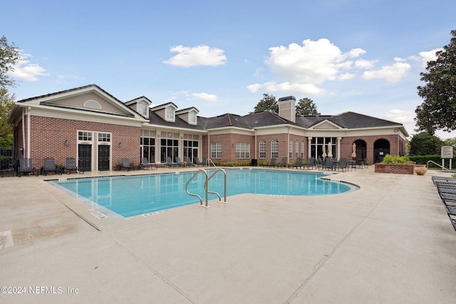 community pool featuring a patio area