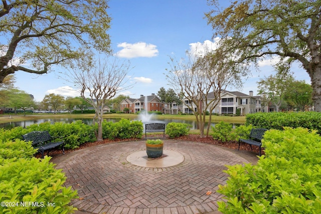 view of patio featuring a water view and a residential view