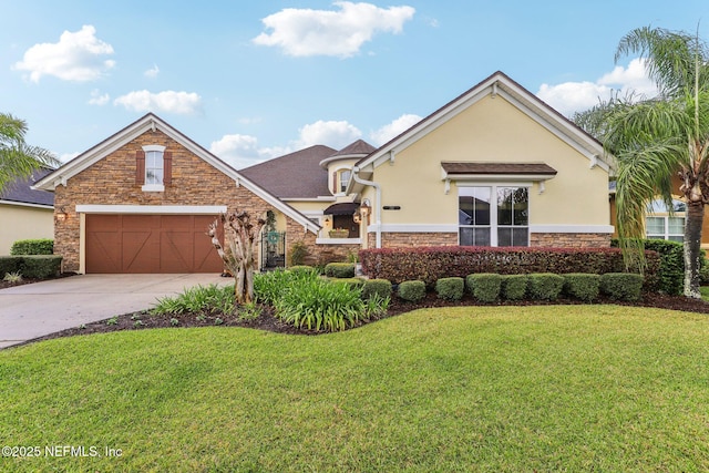 view of front of home with stucco siding, driveway, a front lawn, stone siding, and a garage