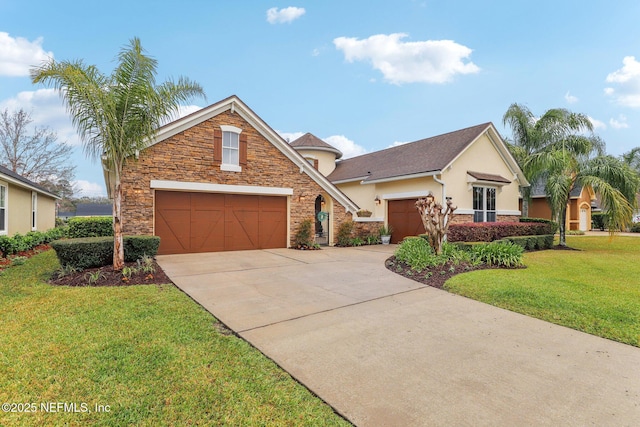 traditional-style home featuring a front yard, stucco siding, a garage, stone siding, and driveway