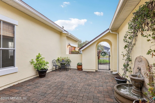 view of patio featuring a gate and fence