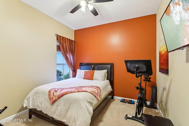 carpeted bedroom with a ceiling fan and baseboards