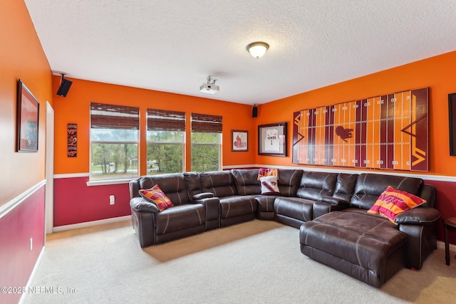 living room with baseboards, a textured ceiling, and carpet flooring