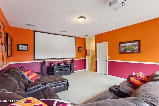 home theater with visible vents, carpet floors, and a textured ceiling