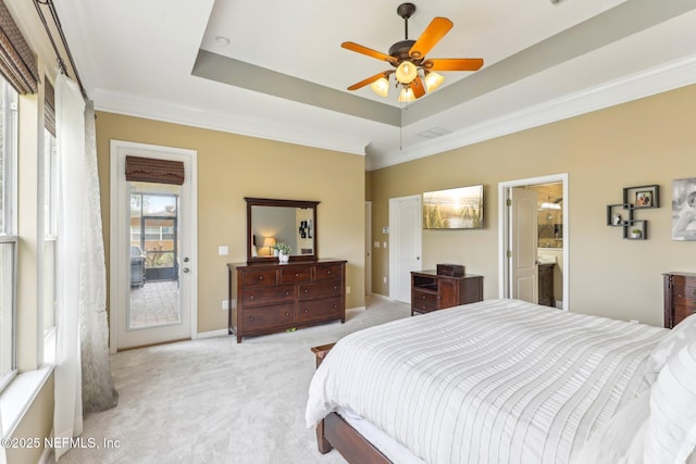 bedroom with a raised ceiling, light colored carpet, ornamental molding, and access to outside