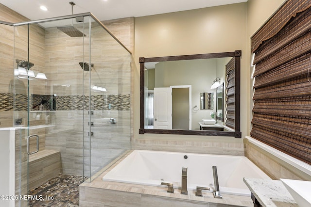 full bath with vanity, a bath, and a stall shower