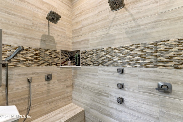 bathroom with tiled shower