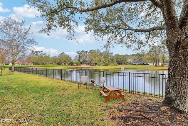 view of yard featuring a water view and fence