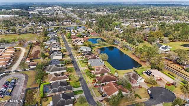 drone / aerial view featuring a residential view and a water view