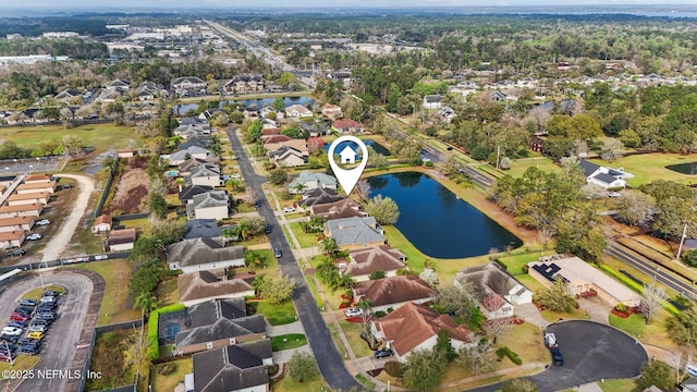 birds eye view of property with a water view and a residential view