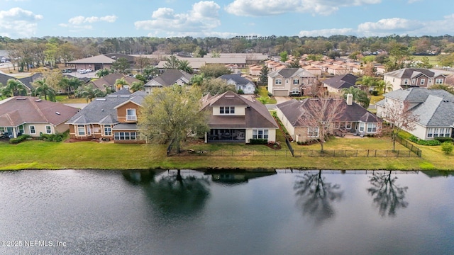 drone / aerial view with a residential view and a water view