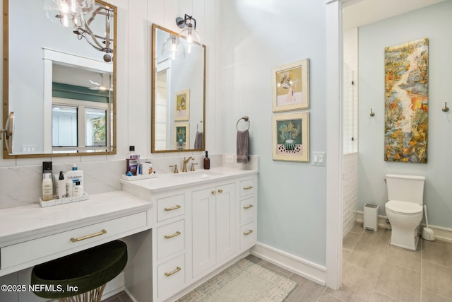 bathroom with tasteful backsplash, baseboards, vanity, and toilet