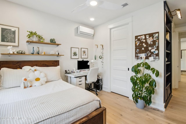 bedroom featuring light wood finished floors, visible vents, a ceiling fan, a wall unit AC, and recessed lighting