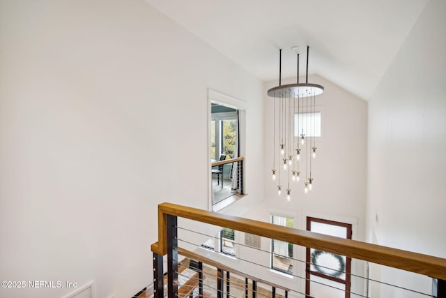 interior space featuring lofted ceiling and an upstairs landing