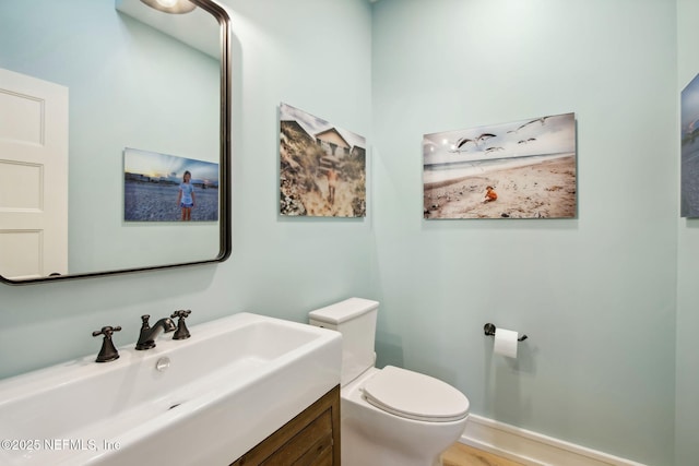 bathroom with toilet and vanity