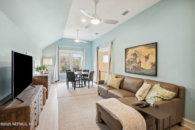 living room with vaulted ceiling, ceiling fan, and visible vents