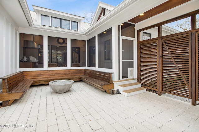 view of patio / terrace featuring a sunroom