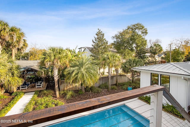 view of swimming pool with a fenced in pool, fence, and a deck