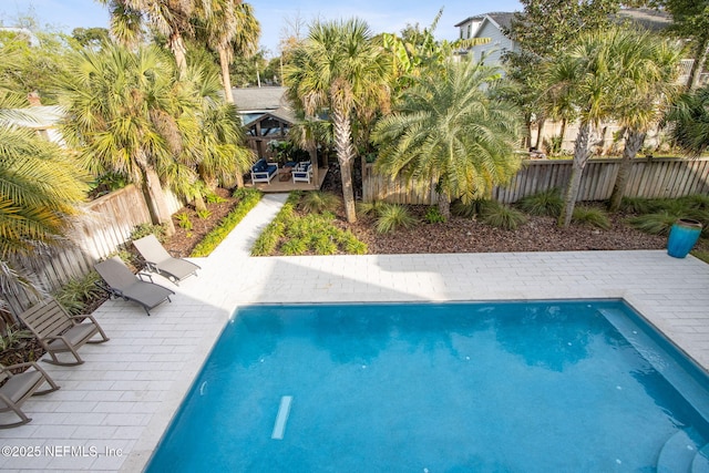 view of pool with a fenced backyard, a fenced in pool, and a patio