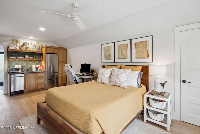 bedroom with light wood-style floors, freestanding refrigerator, a toaster, and lofted ceiling