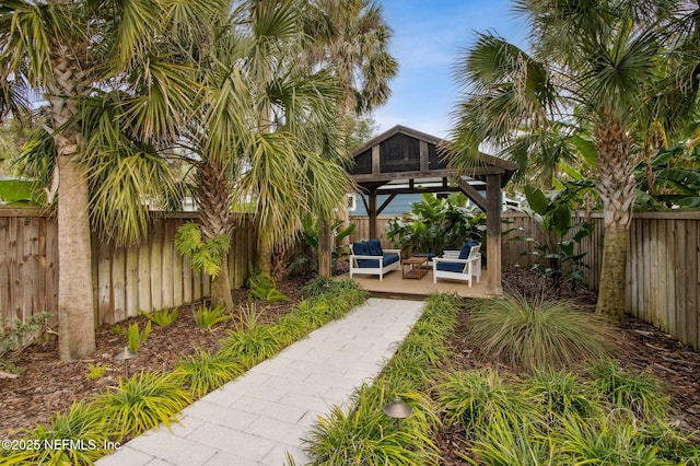 view of yard featuring a fenced backyard, an outdoor living space, and a gazebo