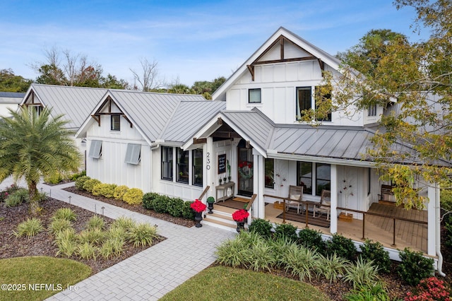 modern farmhouse style home featuring board and batten siding, a standing seam roof, and metal roof