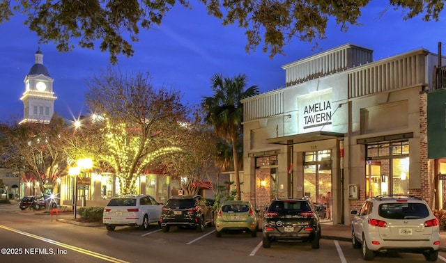 view of building exterior with uncovered parking