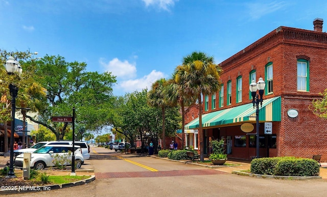 view of road with street lighting, curbs, and sidewalks