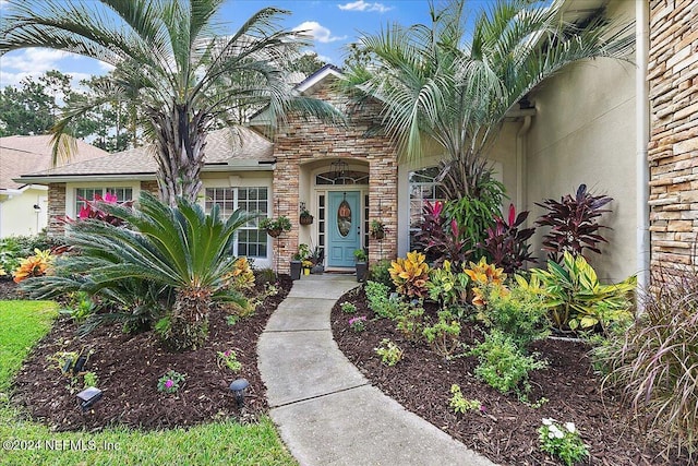 entrance to property with stone siding and brick siding