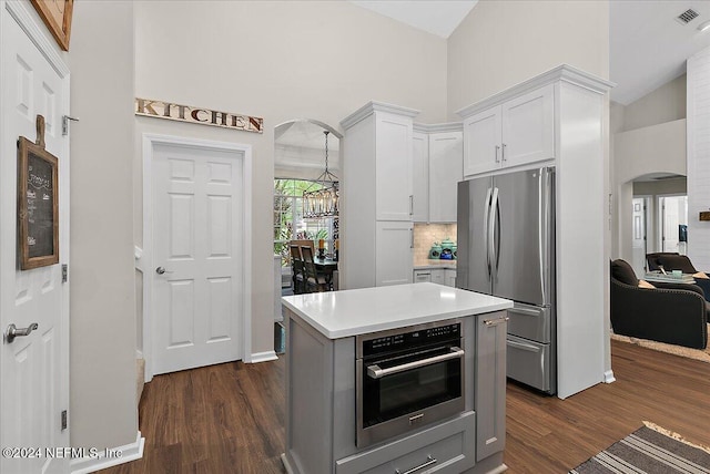 kitchen featuring visible vents, white cabinets, arched walkways, appliances with stainless steel finishes, and light countertops