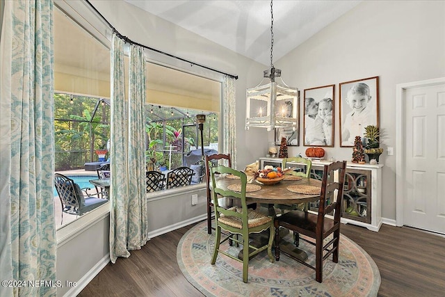 dining room with vaulted ceiling, wood finished floors, and baseboards