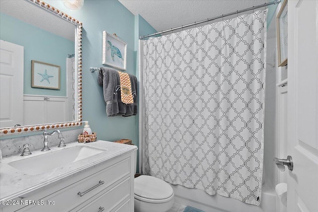 bathroom featuring toilet, vanity, a textured ceiling, and shower / tub combo with curtain