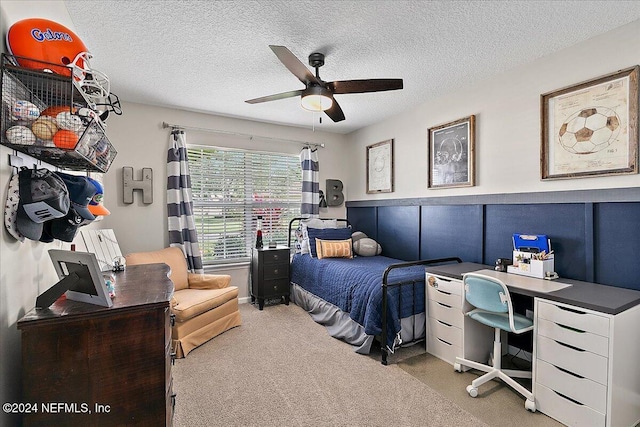 bedroom featuring ceiling fan, a textured ceiling, and carpet flooring