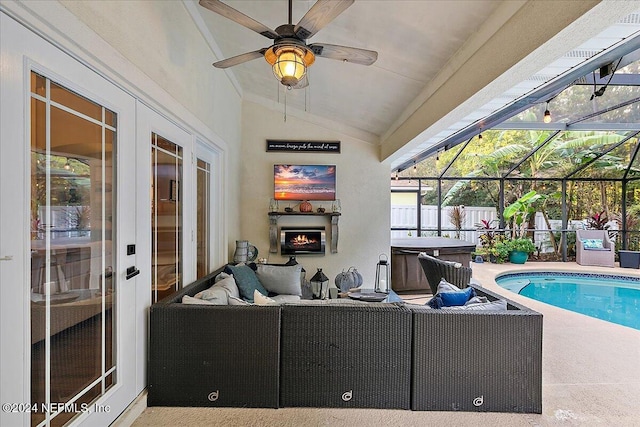 view of pool with a patio, an outdoor living space with a fireplace, glass enclosure, ceiling fan, and fence