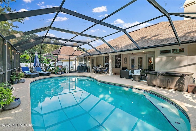 pool with french doors, a patio area, and a hot tub