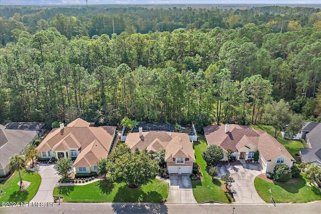 aerial view featuring a wooded view and a residential view