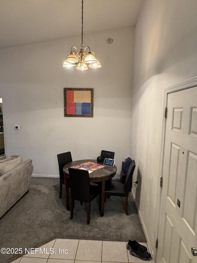 carpeted dining space with tile patterned floors and an inviting chandelier