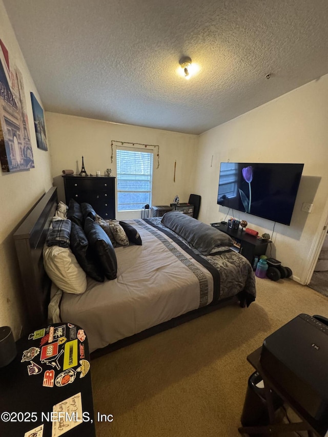 bedroom featuring a textured ceiling and carpet