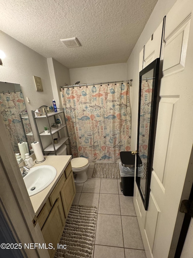 full bathroom featuring a textured ceiling, curtained shower, tile patterned flooring, toilet, and vanity