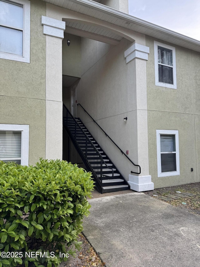 view of exterior entry featuring stucco siding