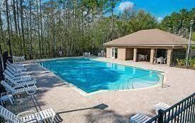 pool featuring a patio area and an outdoor structure