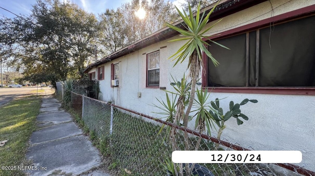 view of property exterior with fence